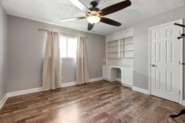 a view of a livingroom with a ceiling fan and window