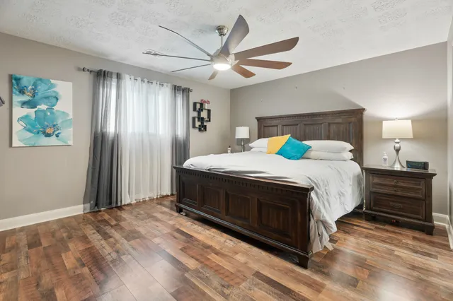 a bedroom with a bed and a chandelier