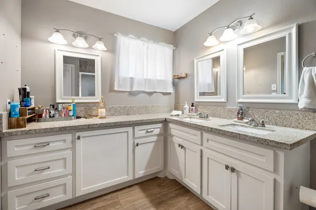 a bathroom with a sink vanity and mirror