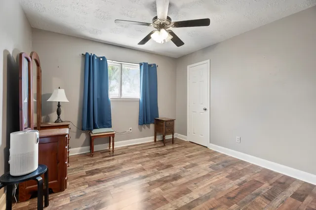 a bedroom with furniture window and wooden floor
