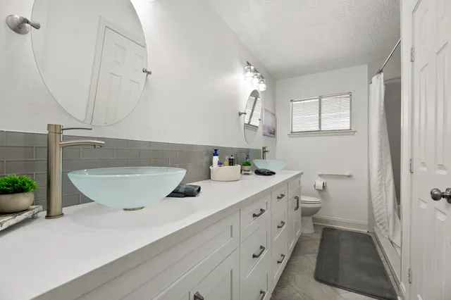 a bathroom with a double vanity sink and a mirror