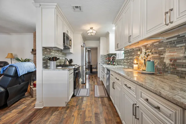 a kitchen with sink cabinets and wooden floor