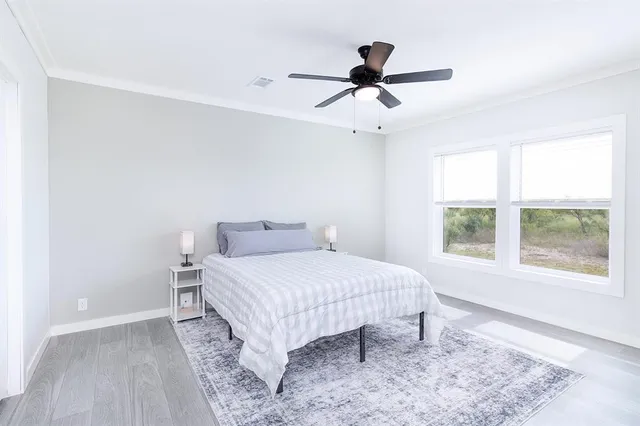 a bedroom with a bed and a large window