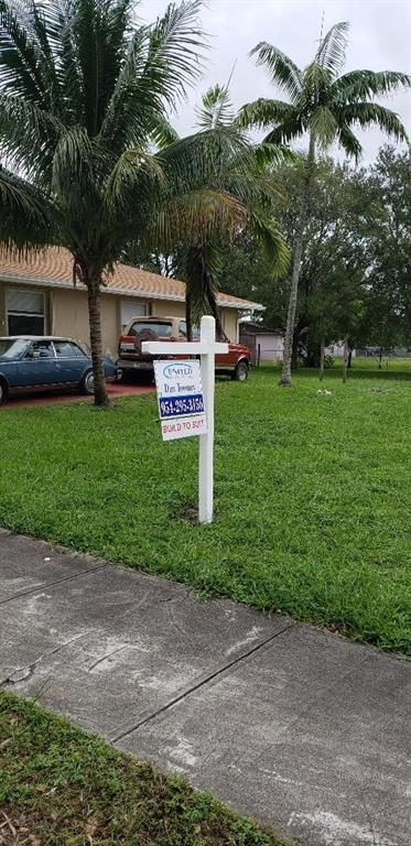 4430 Southwest 57th Avenue Davie, FL 33314 - Photo 2 of 3 a view of a park that has a sign board large trees