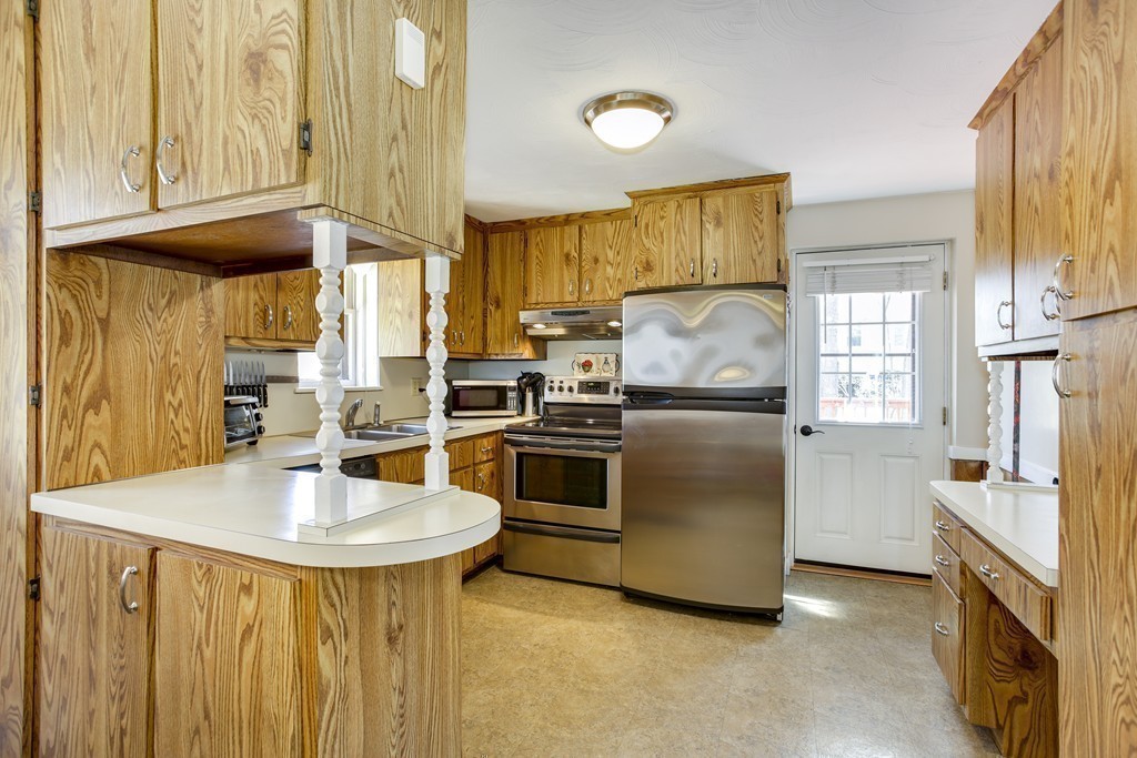13 Cypress Road Natick, MA 01760 - Photo 16 of 24 a kitchen with stainless steel appliances granite countertop a refrigerator a sink and a stove