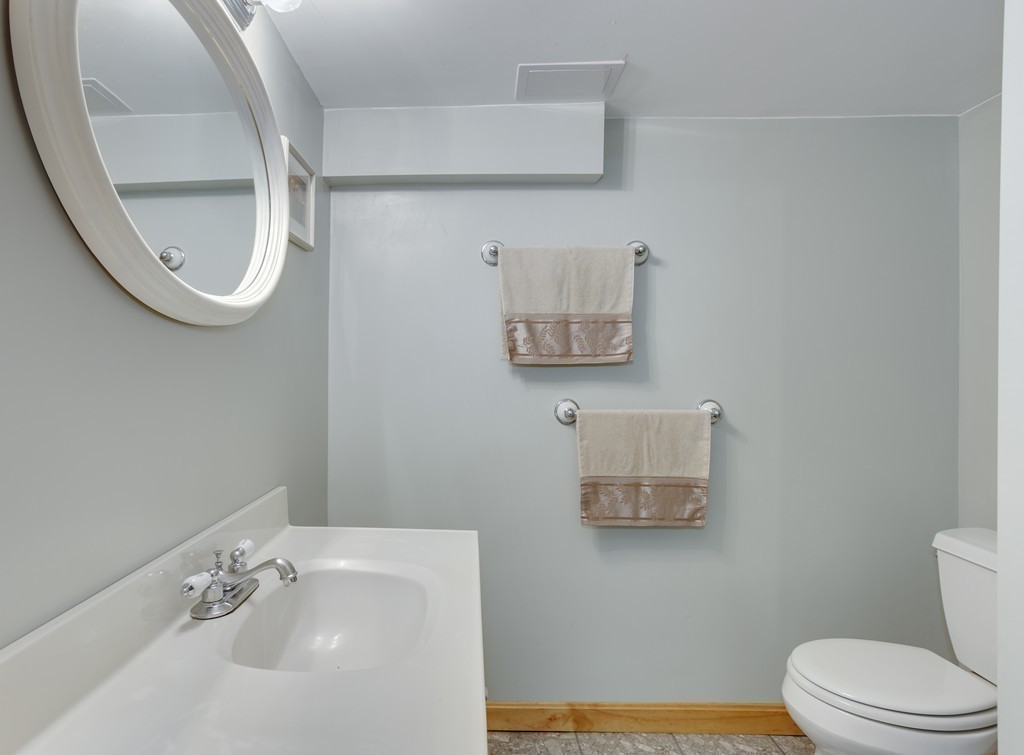 13 Cypress Road Natick, MA 01760 - Photo 24 of 24 a bathroom with a sink mirror and toilet