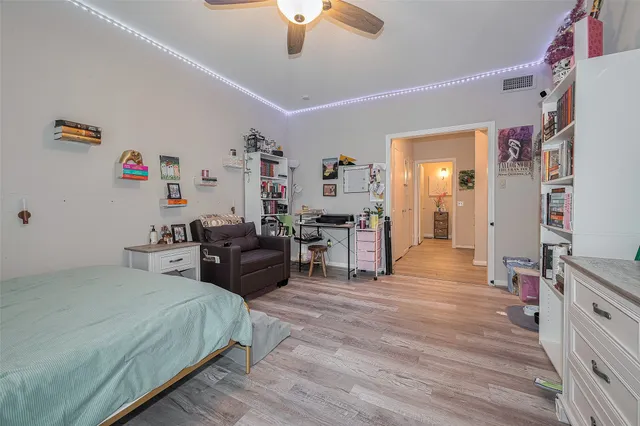 a bedroom with furniture and a wooden floor