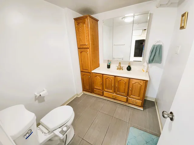 a bathroom with a sink mirror vanity and toilet