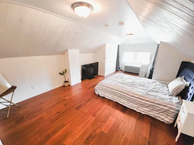 a bedroom with a bed and a dresser