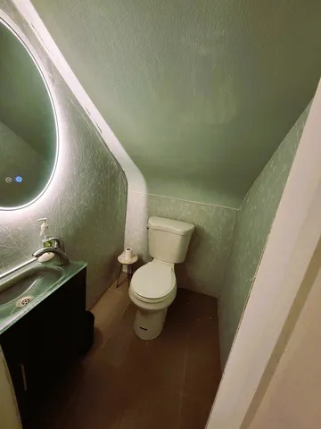 a bathroom with a toilet and a sink
