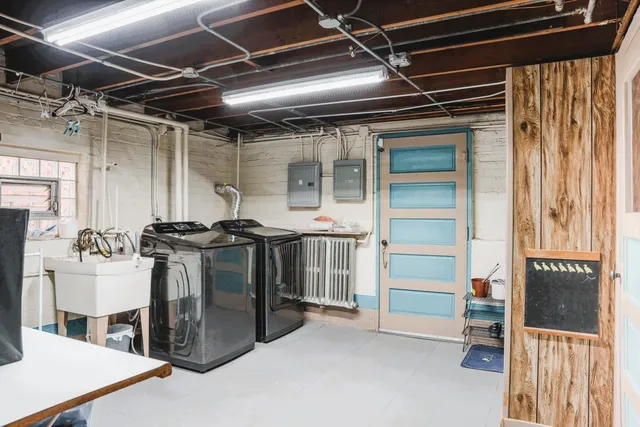 a utility room with stainless steel appliances kitchen island a stove and a refrigerator