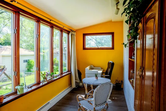a balcony with chairs and a table
