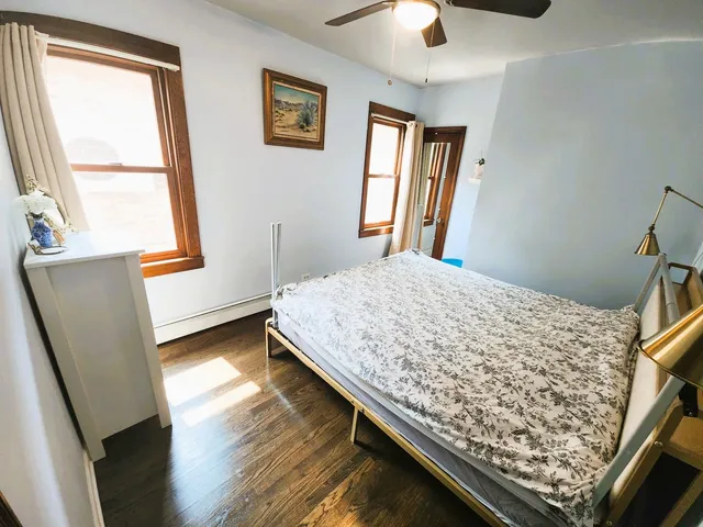 a bedroom with a bed and a window