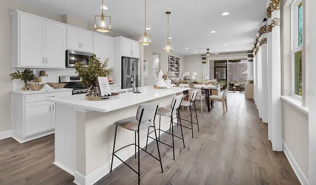 a kitchen with kitchen island granite countertop a table and chairs