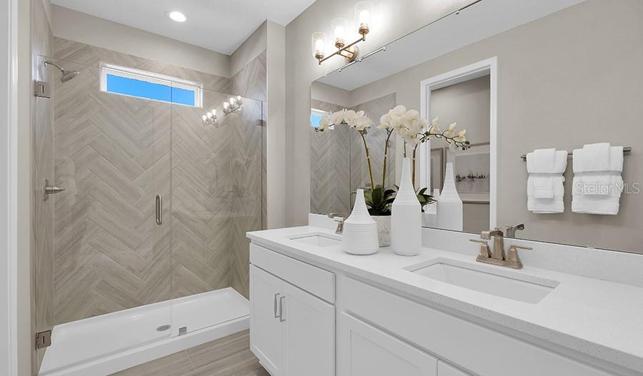 5129 Spring Maiden Circle Apollo Beach, FL 33572 - Photo 7 of 17 a bathroom with a sink a shower a mirror and a bathtub