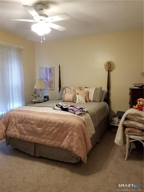 26 4th Street Hamden, CT 06514 - Photo 7 of 40 a bedroom with a bed and a chandelier