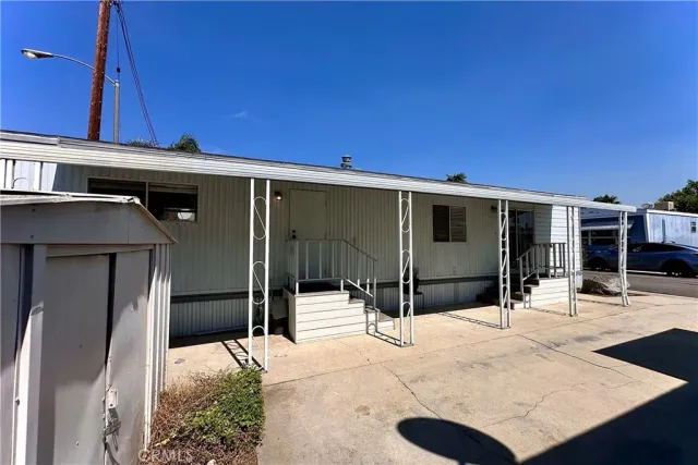 a backyard of a house with table and chairs