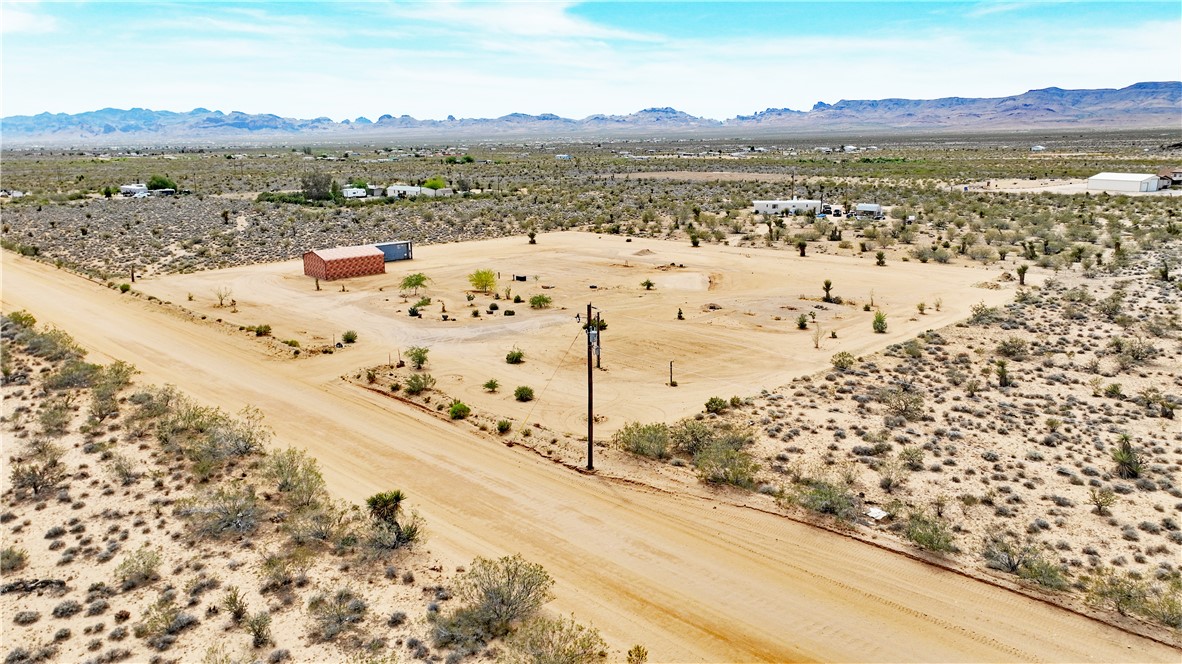 5649 Davis Road Golden Valley, AZ 86413 - Photo 8 of 24 Expansive desert landscape featuring a dirt road and scattered vegetation