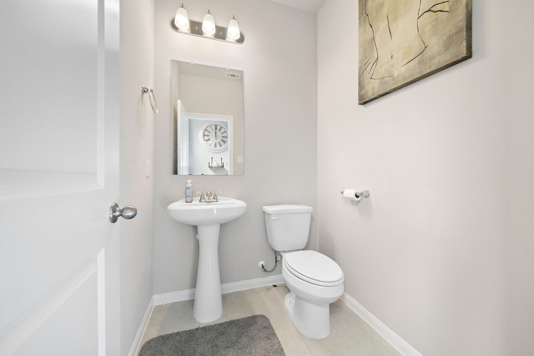 31203 Balsam Hawk Lane Hockley, TX 77447 - Photo 11 of 19 a bathroom with a toilet sink and mirror