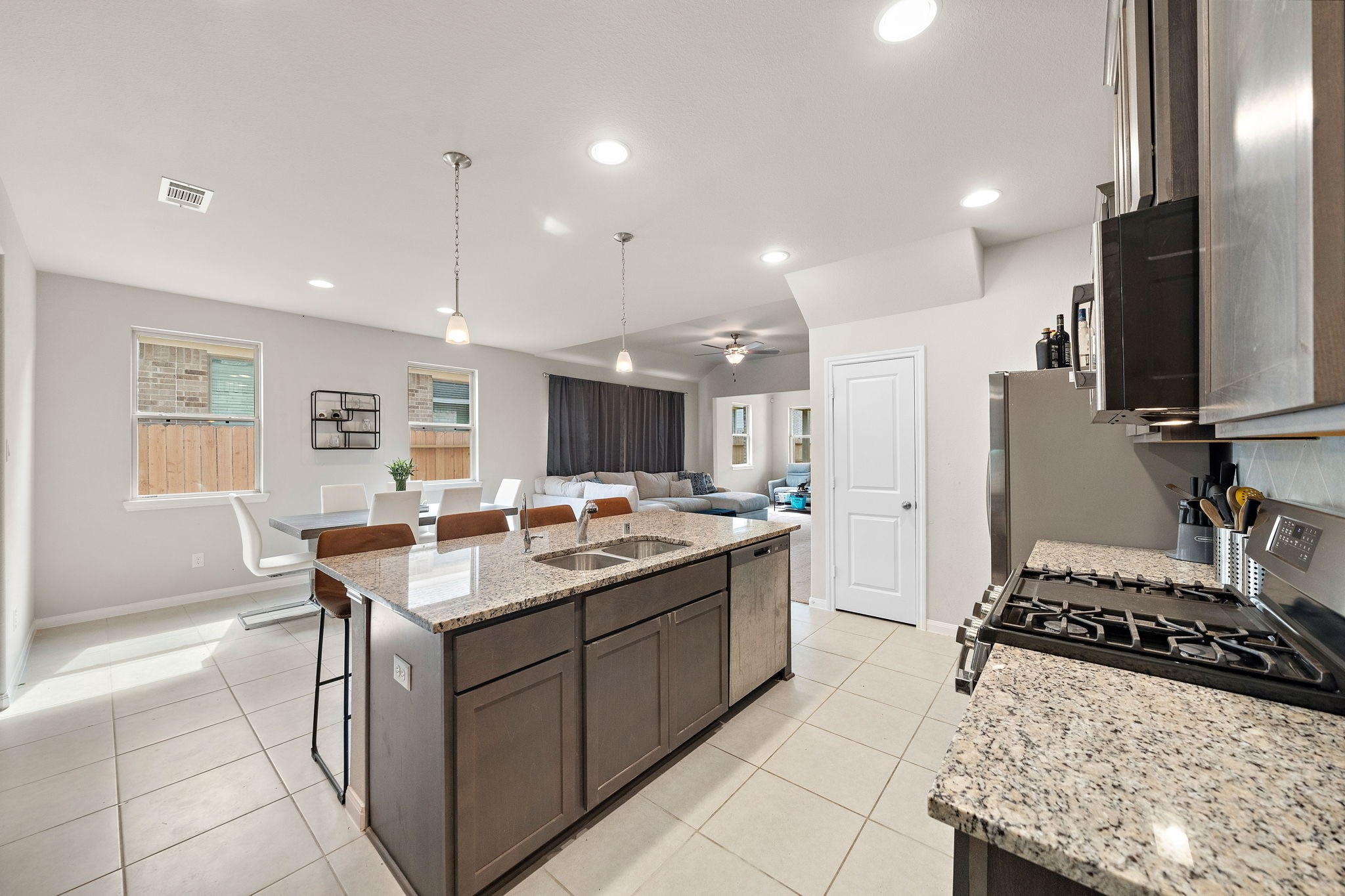 31203 Balsam Hawk Lane Hockley, TX 77447 - Photo 4 of 19 a kitchen with kitchen island a sink stove and refrigerator