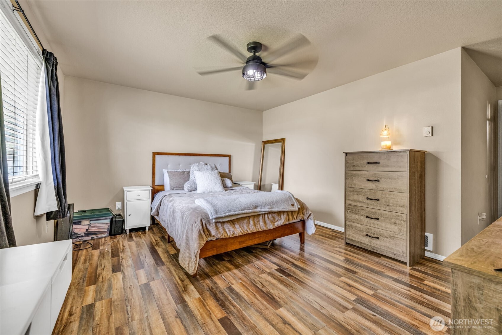 10313 School Land Road Southwest Rochester, WA 98579 - Photo 22 of 40 a bedroom with a bed and a ceiling fan