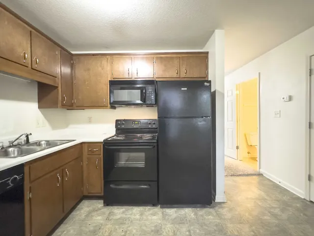 a kitchen with a sink and a refrigerator