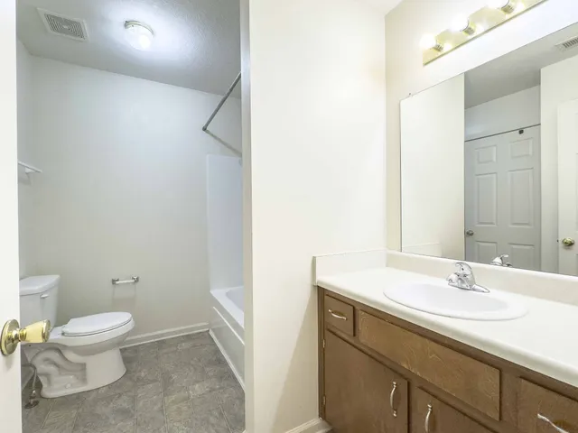 a bathroom with a sink toilet and vanity