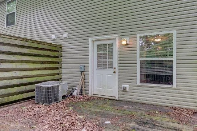 a view of a house with a small yard and a garage