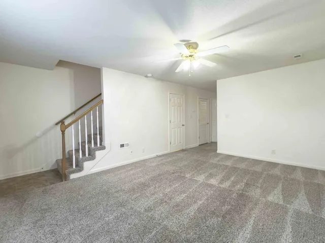 a view of an empty room with a fan