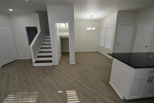 a kitchen with stainless steel appliances a refrigerator a sink a stove a microwave and white cabinets