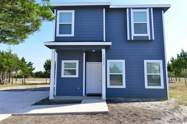 a view of a house with a door and wooden floor