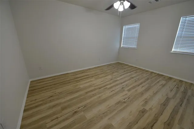 a bathroom with a granite countertop toilet sink and mirror