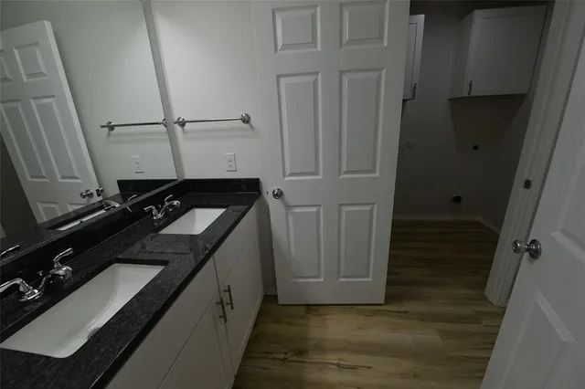 a view of an empty room with a chandelier fan