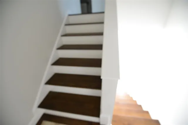 a view of a room with wooden floor and a window