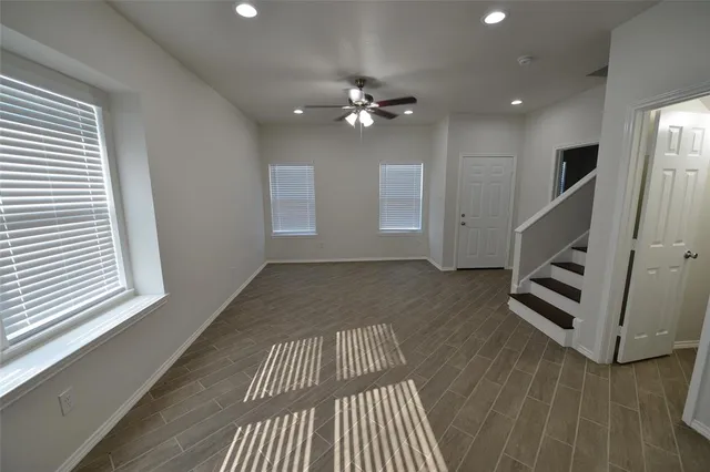 wooden floor in an empty room with a window