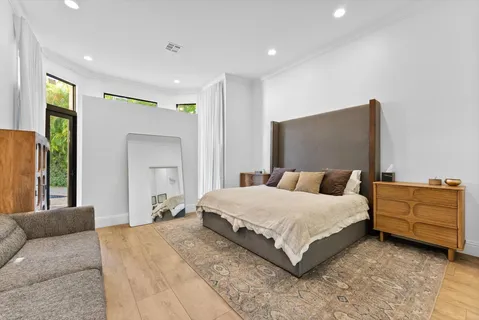 a bedroom with a bed couch and a window