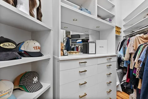 a view of a hallway with wooden floor and furniture