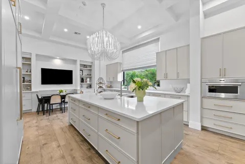 a kitchen with stainless steel appliances a refrigerator sink and cabinets