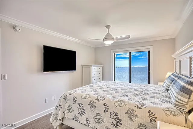 a bedroom with a large bed and a chandelier
