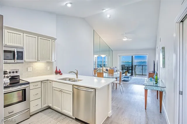 a kitchen with cabinets stainless steel appliances and a counter space