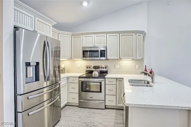 a kitchen with a sink cabinets and stainless steel appliances