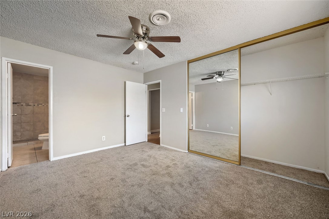 6321 Portola Road Las Vegas, NV 89108 - Photo 13 of 29 A well-lit bedroom provides ample closet space and convenient bathroom access.
