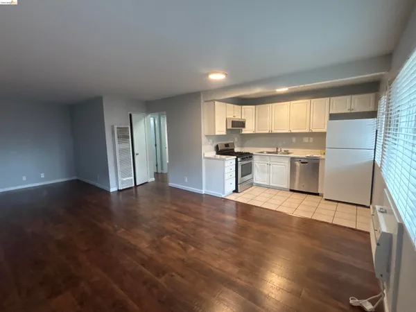 a view of a kitchen with a sink cabinets and wooden floor