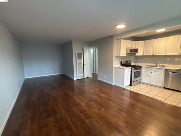a view of kitchen with wooden floor and electronic appliances