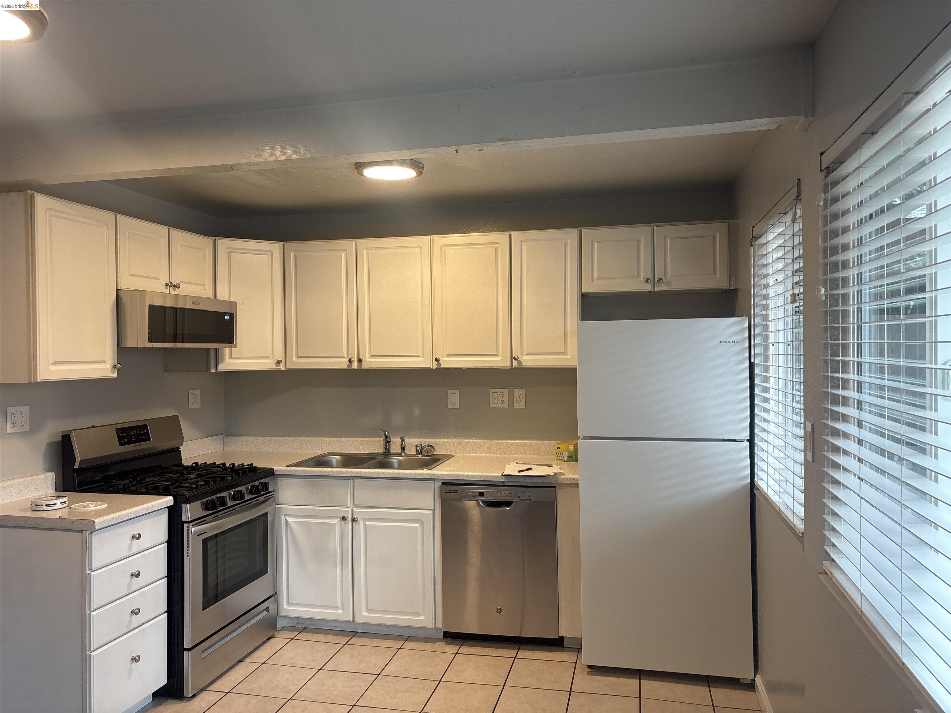 4462 Clayton Road, Unit A Concord, CA 94521 - Photo 9 of 11 a kitchen with white cabinets and white appliances