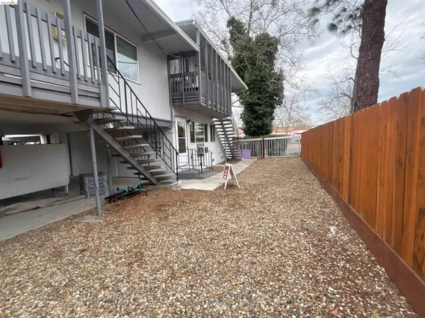 a view of a house with wooden fence