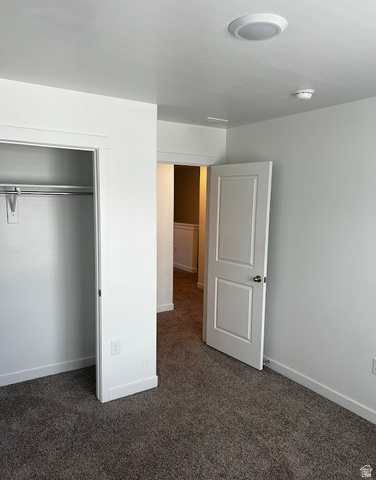 562 Hal Street, Unit 152 Tooele, UT 84074 - Photo 13 of 44 Room featuring a neutral carpet, white walls, and a built-in closet with a hanging rod