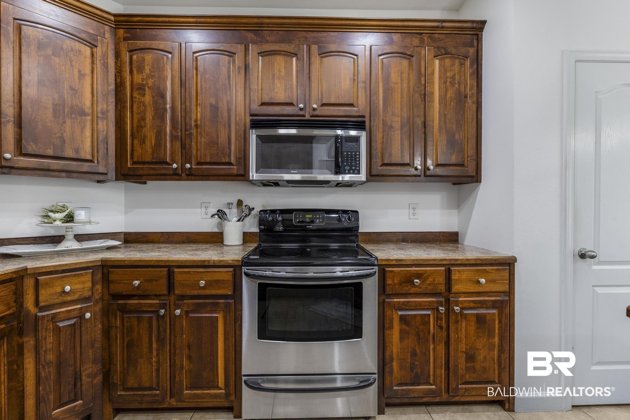 35814 Delvan Lane Bay Minette, AL 36507 - Photo 19 of 53 Kitchen featuring wood cabinetry with white knobs, a stainless steel range, and a built-in microwave