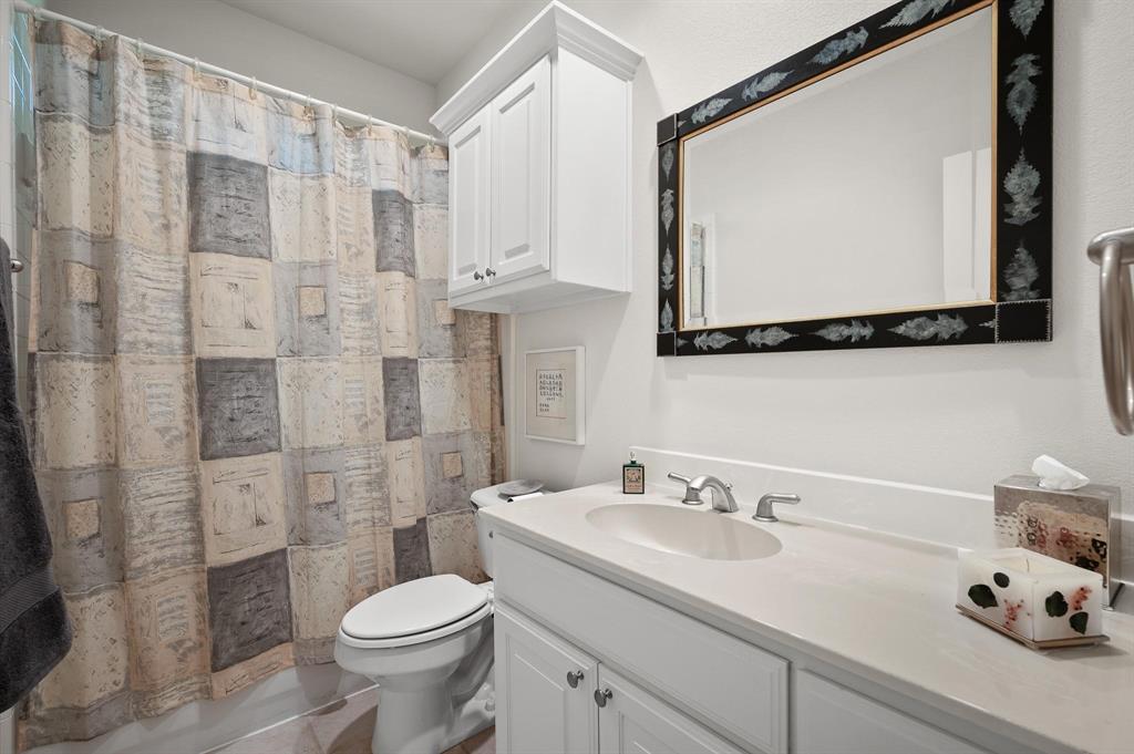 4209 Sexton Lane Dallas, TX 75229 - Photo 26 of 27 a bathroom with a sink a toilet and shower