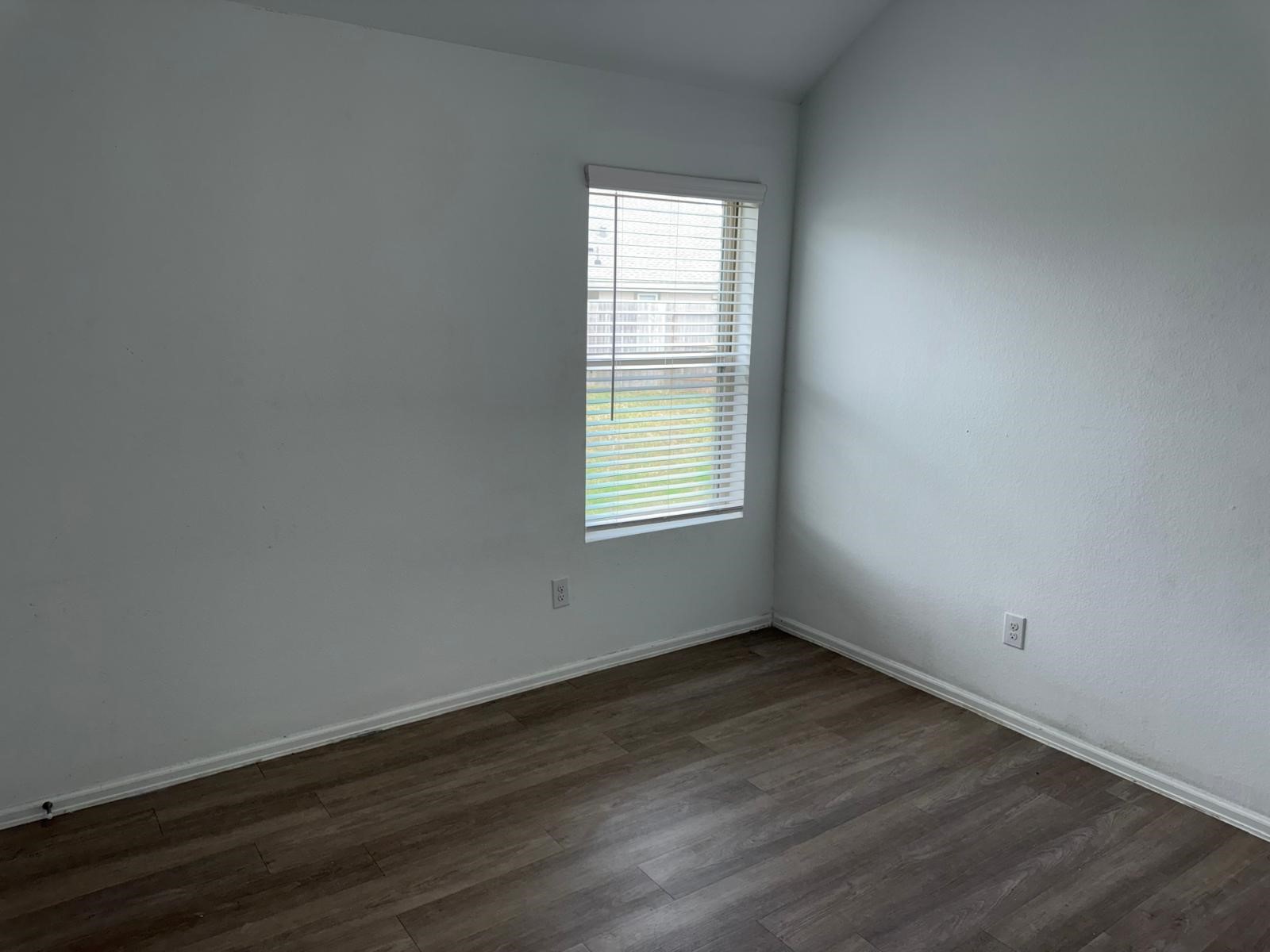 5335 Winding Strm Drive Rosenberg, TX 77469 - Photo 14 of 26 an empty room with wooden floor and windows